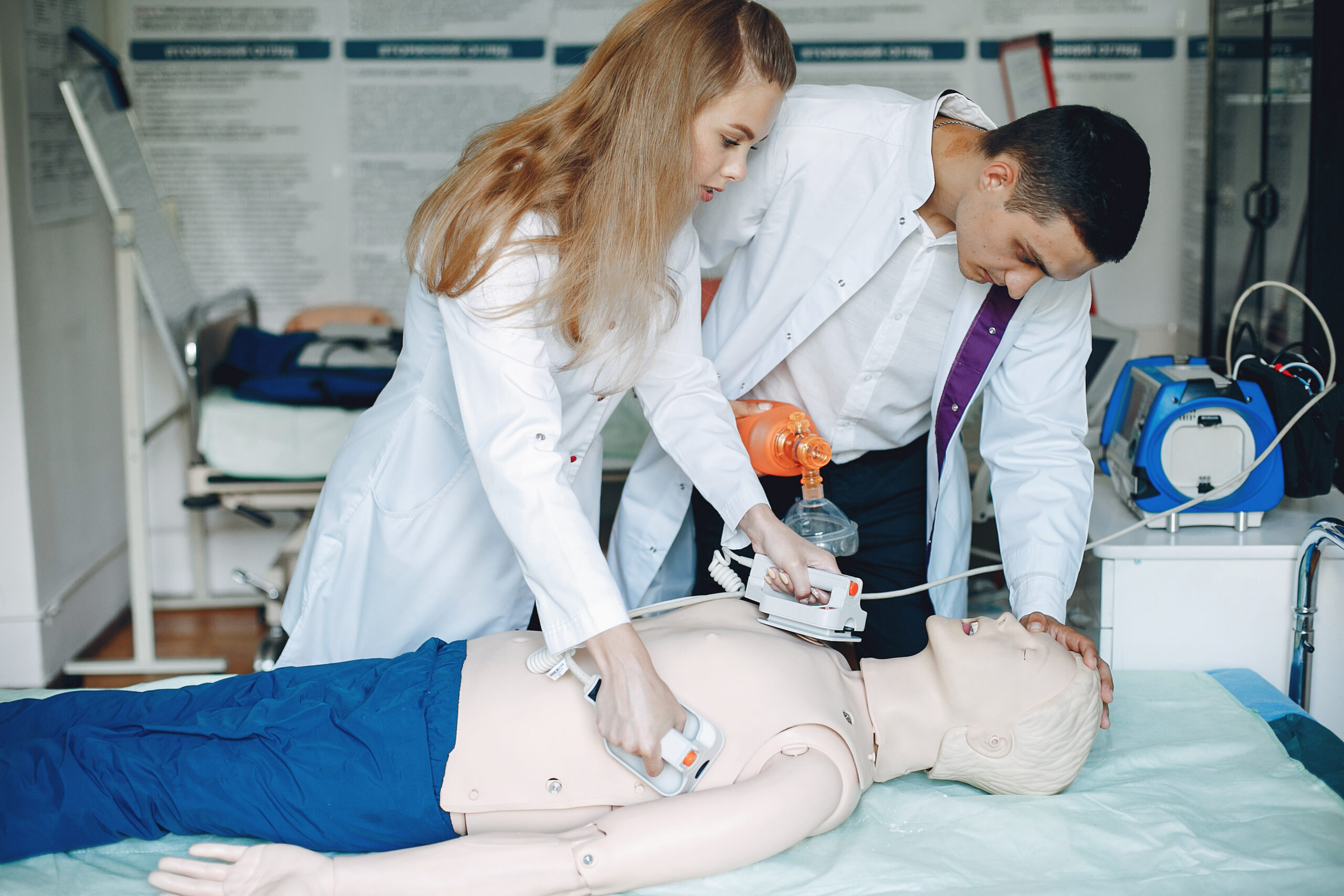 man and woman are learning to provide first aid.